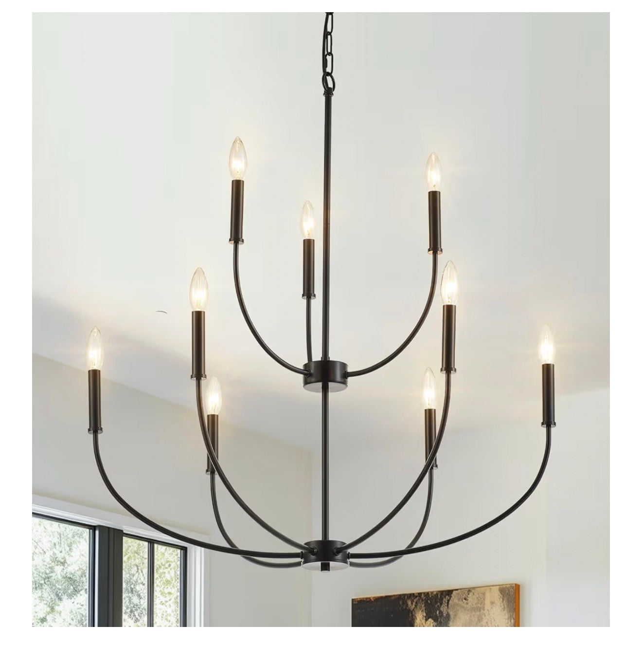 Black chandelier with multiple lights on a white wall background