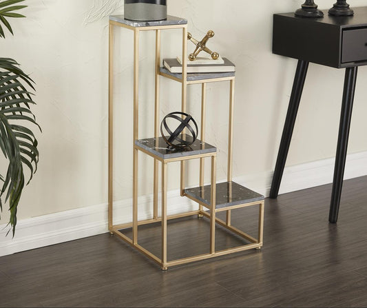 Decorative gold side table with a black vase and plant in a room setting.