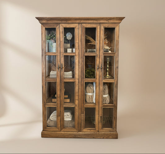 Wooden display cabinet with glass doors and decorative items