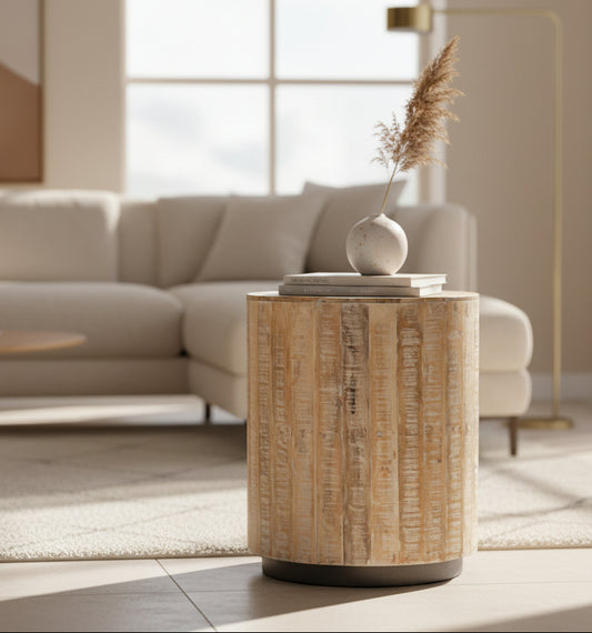 Round wooden side table with a textured surface on a white background