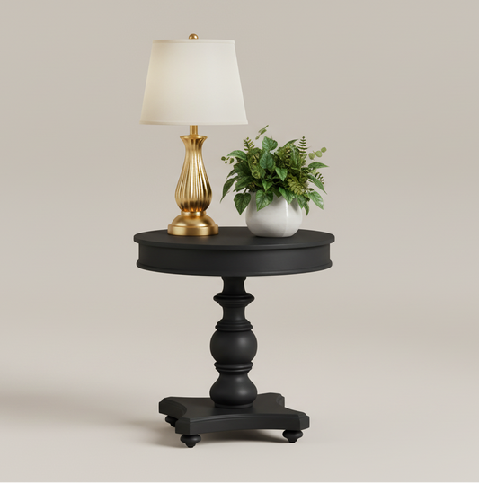 Black round side table with a pedestal base on a white background