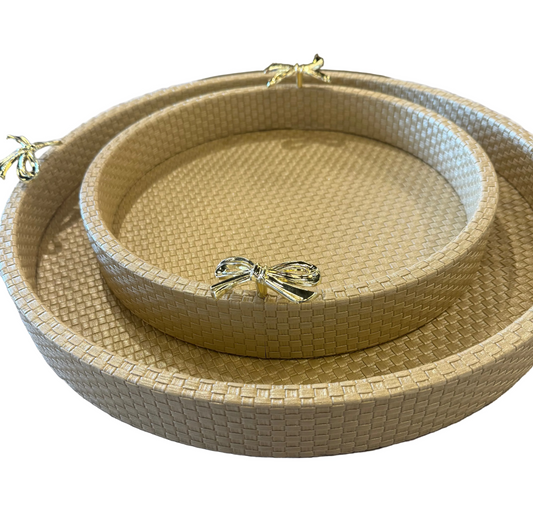 Set of woven trays with a decorative bow on a patterned surface