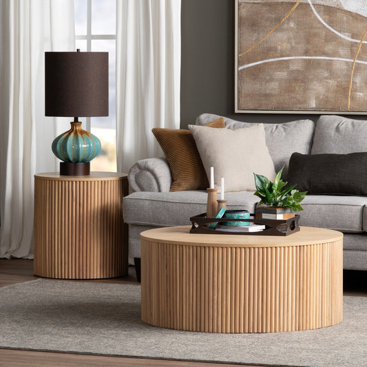Living room with round wooden coffee table, side table, and gray sofa.