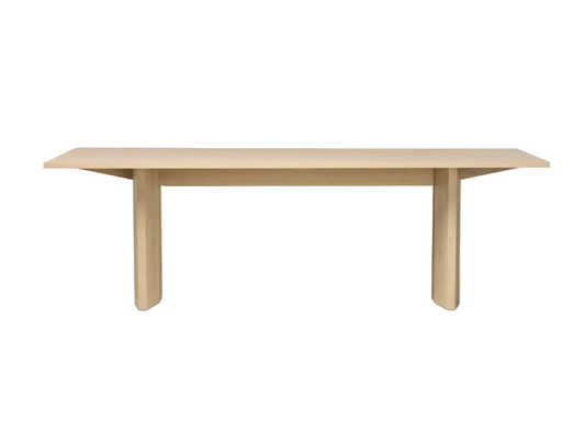 Light wood dining table on a white background