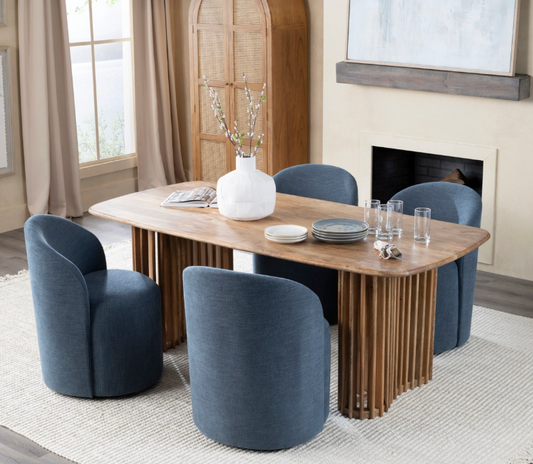 Dining room with wooden table and blue chairs near a fireplace