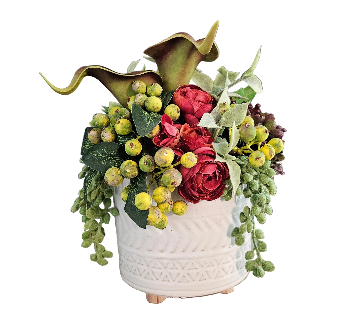 Decorative flower arrangement in a white textured vase on a wooden surface with a gray background