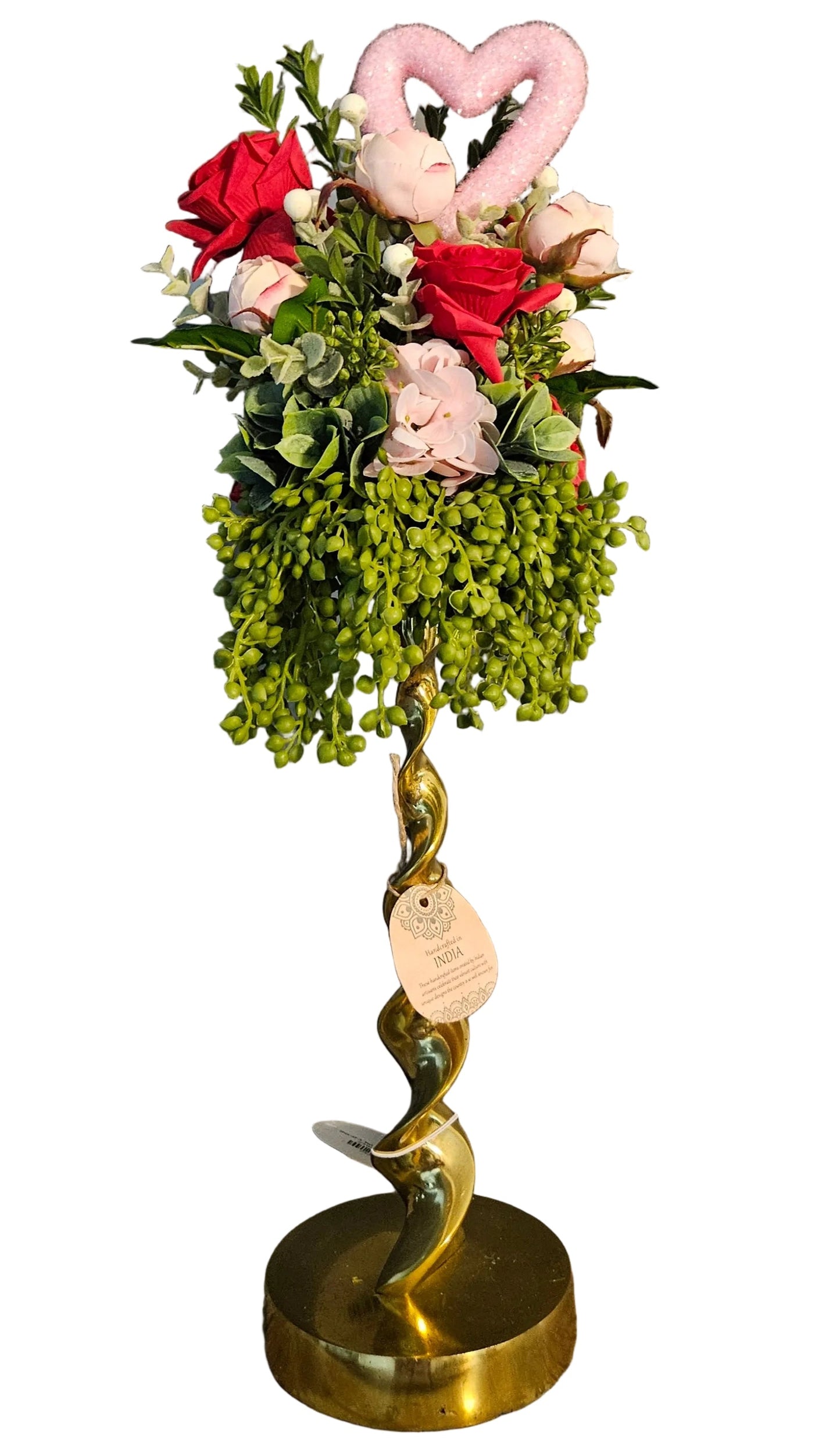 Decorative item with flowers, pink heart, and gold base on a white background