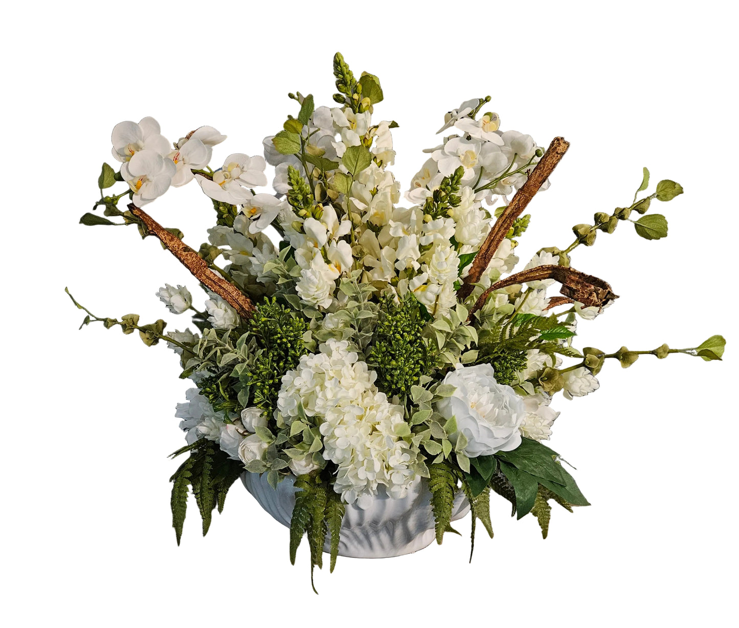 Floral arrangement in a white vase on a wooden surface with decorative text in the background.