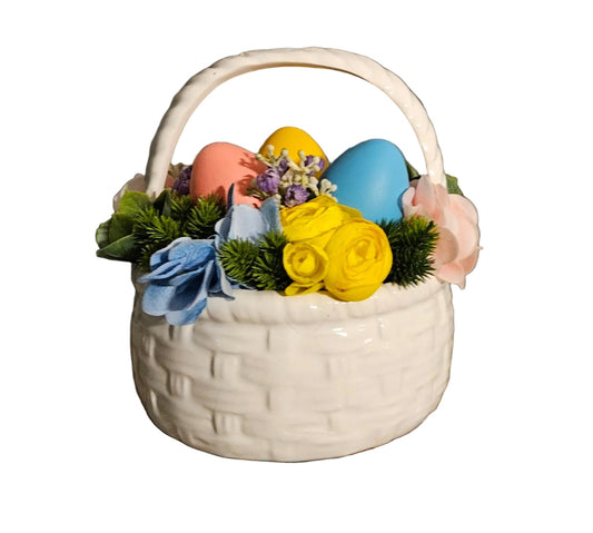 Decorative Easter basket with colorful eggs and flowers on a rustic wooden surface.