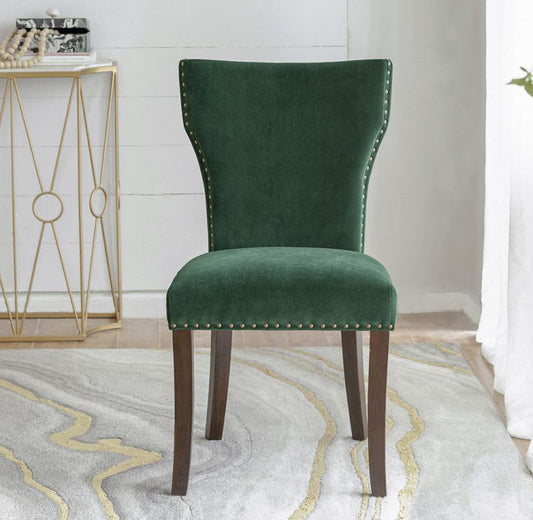 Green velvet dining chair with nailheads and dark wood legs