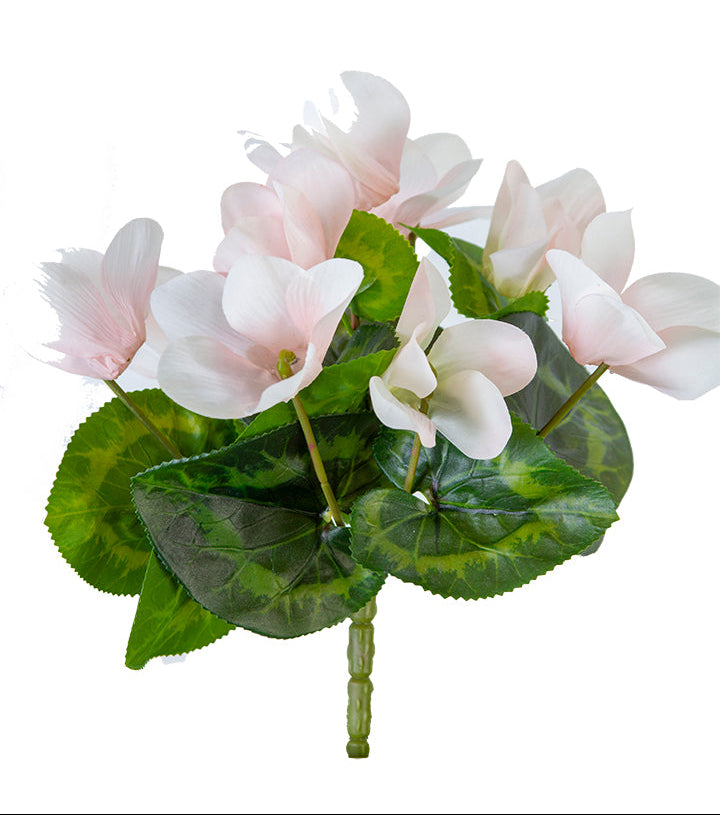 Artificial flower arrangement with pink flowers and green leaves on a white background