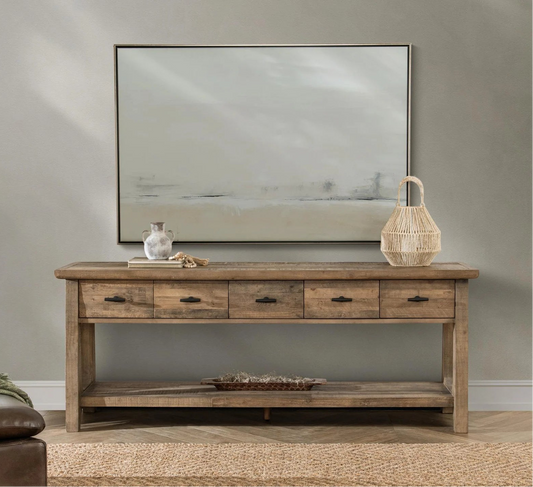 Wooden sofa and/or console table with decorative items against a gray wall