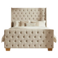 Beige tufted bed with matching pillows on a white background