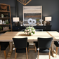 Dining room setup with a table and chairs in a showroom.