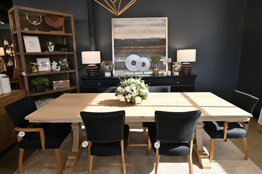 Dining room setup with a table and chairs in a showroom.
