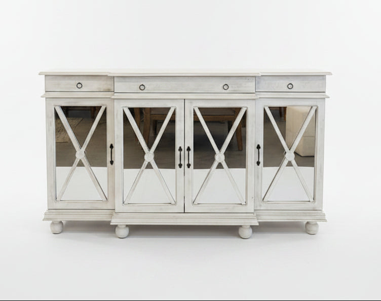 White sideboard with decorative items on a white background