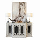 White cabinet with decorative items and a large horse painting on a wall.
