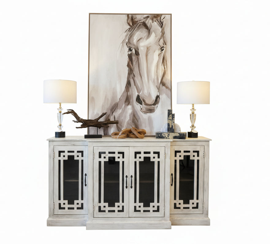 White cabinet with decorative items and a large horse painting on a wall.