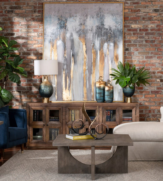 A dark brown Union Row Sideboard with window pane accents, featuring a console table on top, placed in a room with a brick wall and wooden furniture.