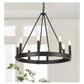 Black chandelier hanging in a room with white walls and a window.