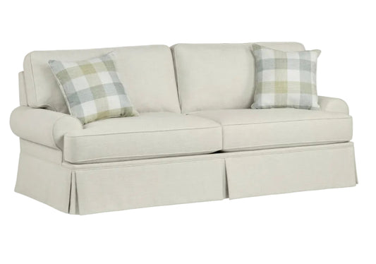 Beige sofa with plaid cushions on a white background