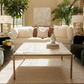 Coffee table with a agate surface in front of a beige sofa with decorative pillows.