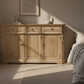 Wooden sideboard with three drawers and three doors on a white background
