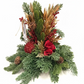 A festive artificial Christmas wreath centerpiece with green pine branches, gold glittery wheat, red berries, pinecones, and a red fabric rose, displayed on a wooden table in a store setting.