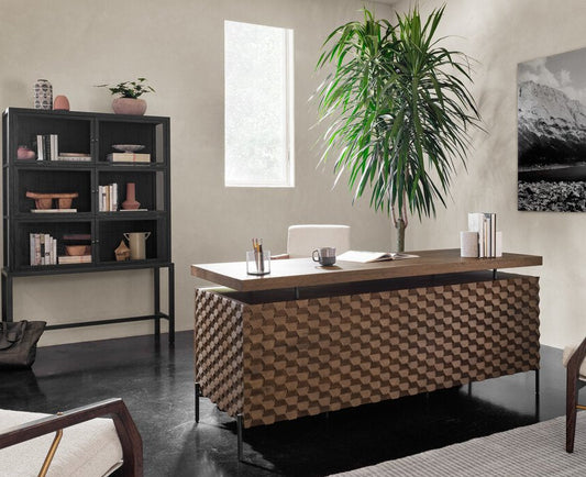 Modern office interior with a desk, bookshelf, and decorative elements.