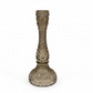 Decorative glass candle holder on a white surface with a blurred background