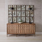 Wooden sideboard with framed botanical prints on a wall.