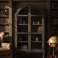 Dark wooden bookshelf with arched top and gold legs on a white background