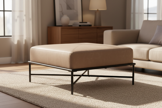 Beige ottoman with black metal frame on a white background