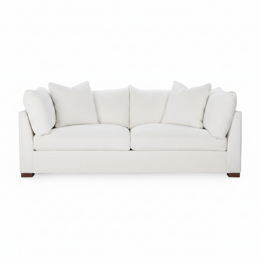 White sofa with cushions on a white background