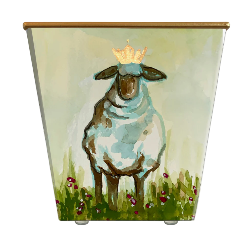 Painted container with a sheep wearing a crown in a grassy field