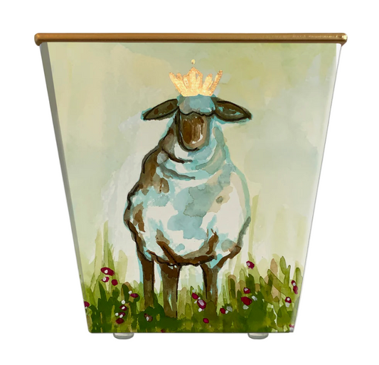 Painted container with a sheep wearing a crown in a grassy field