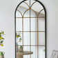 Decorative mirror with a grid pattern in a room with a table and chair.