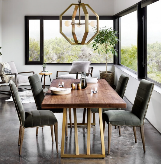 Modern dining room with wooden table and gray chairs near large windows.