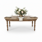 Wooden dining table with extended leaves in a studio setting