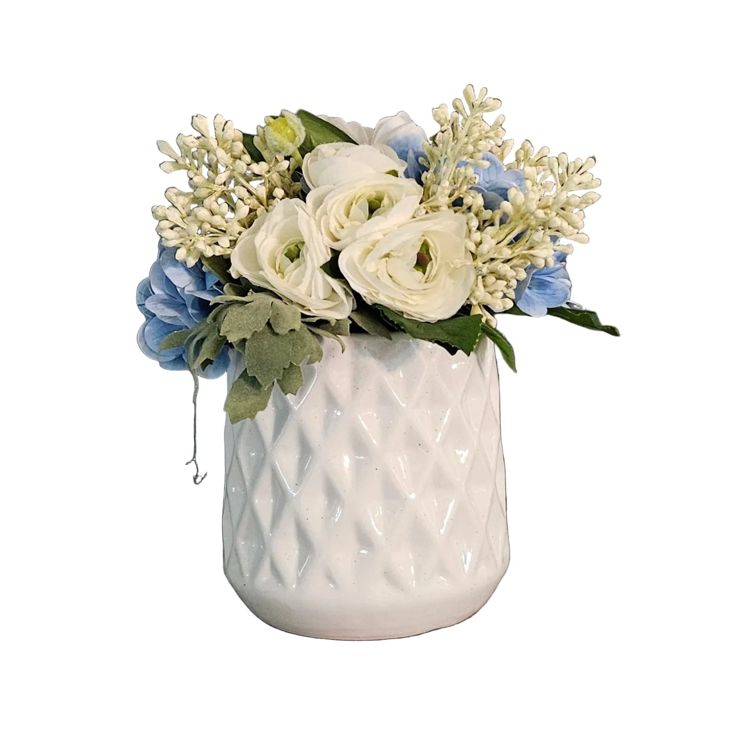 White textured vase with a bouquet of flowers on a white wall.