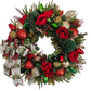 Decorative Christmas wreath with red flowers, gold and green ornaments on a white door.