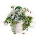 Floral arrangement in a white pot on a wooden surface with a gray wall background