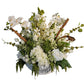 Floral arrangement in a white vase on a wooden surface with decorative text in the background.