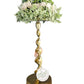 Decorative lamp with green floral arrangement on a white background