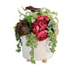 Decorative flower arrangement in a white textured vase on a wooden surface with a dark gray background
