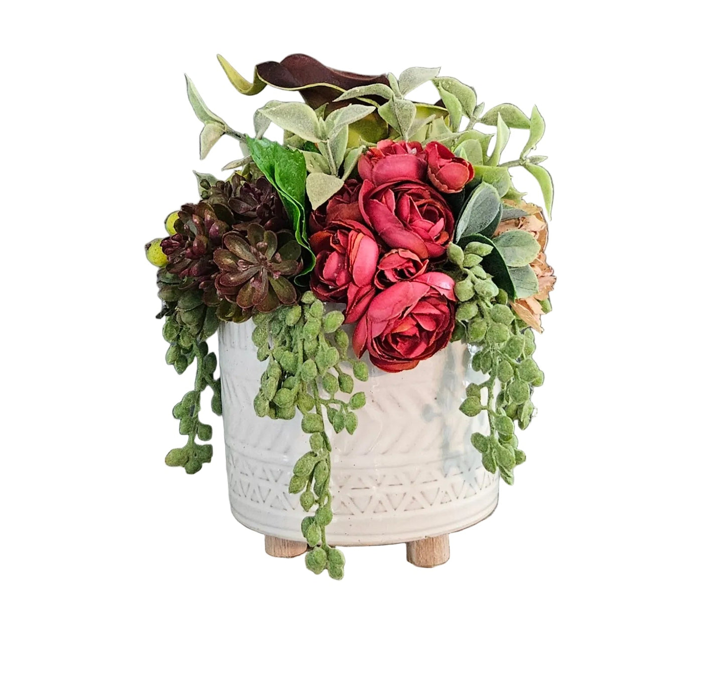 Decorative flower arrangement in a white textured vase on a wooden surface with a dark gray background