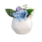 Small white vase with decorative flowers on a white background