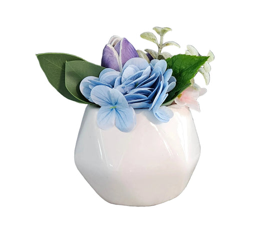 Small white vase with decorative flowers on a white background